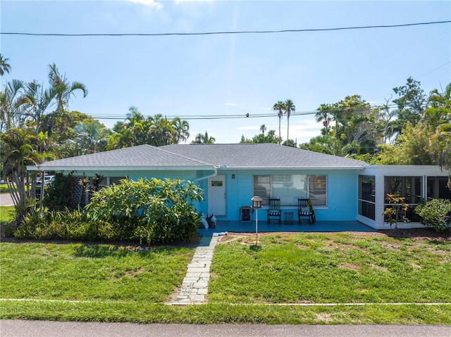 single story home with a front yard and a sunroom