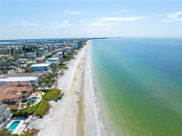 birds eye view of property featuring a water view and a beach view