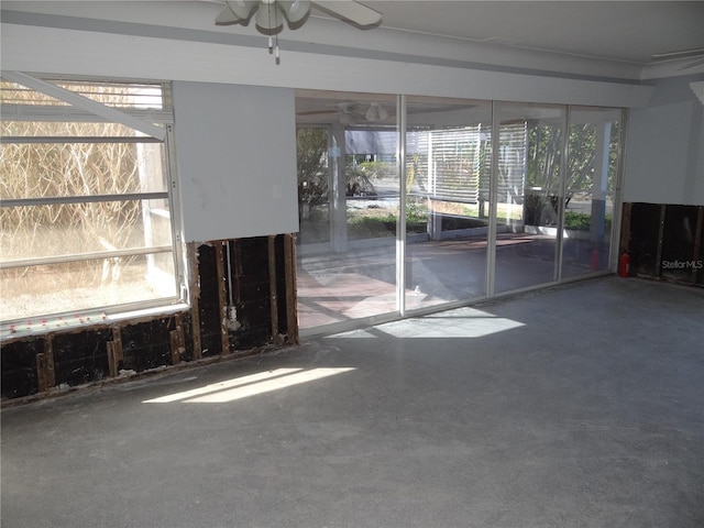 unfurnished living room featuring ceiling fan