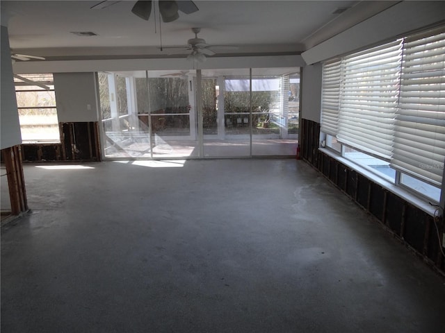 interior space featuring ceiling fan and a healthy amount of sunlight