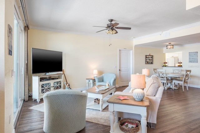 living room featuring crown molding, dark hardwood / wood-style flooring, and ceiling fan