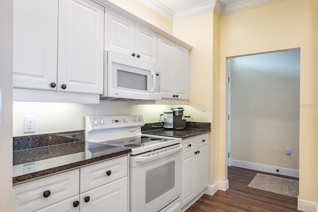 kitchen featuring white cabinetry, dark hardwood / wood-style flooring, dark stone countertops, crown molding, and white appliances