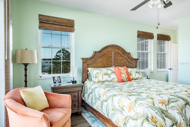 bedroom with ceiling fan and dark hardwood / wood-style flooring