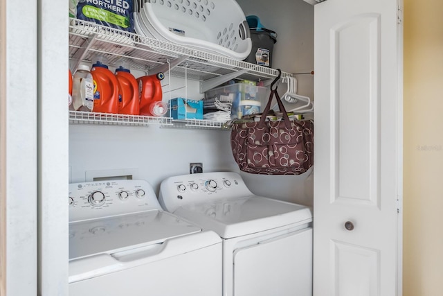 clothes washing area featuring washer and dryer