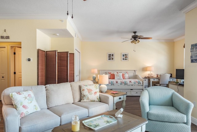 living room with ceiling fan, dark wood-type flooring, a textured ceiling, and ornamental molding