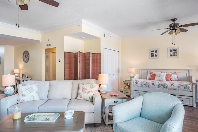 living room with a textured ceiling, dark hardwood / wood-style flooring, ceiling fan, and crown molding