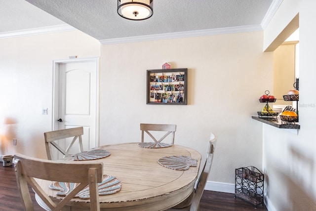 dining room with a textured ceiling, dark hardwood / wood-style floors, and ornamental molding