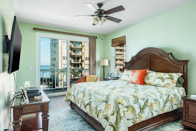 bedroom with hardwood / wood-style flooring, ceiling fan, access to outside, and multiple windows