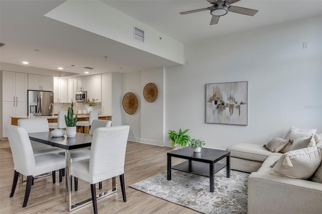 dining area featuring light hardwood / wood-style flooring and ceiling fan