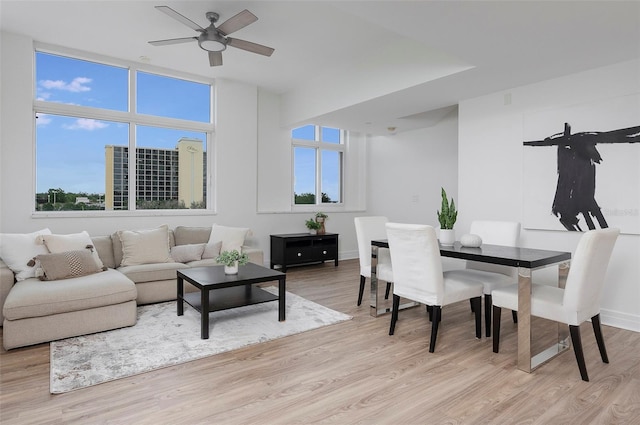 living room with light hardwood / wood-style flooring and ceiling fan