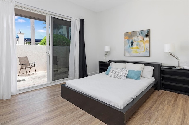 bedroom with light hardwood / wood-style flooring and access to exterior