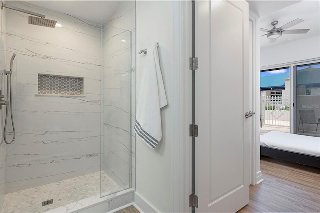 bathroom featuring walk in shower, hardwood / wood-style floors, and ceiling fan