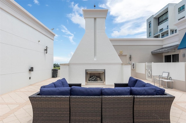 view of patio / terrace with an outdoor living space with a fireplace