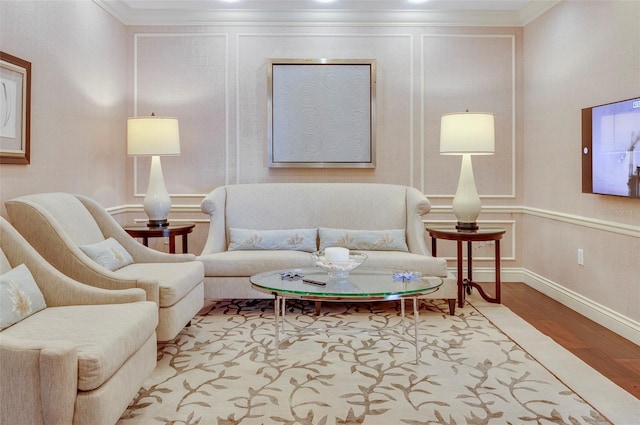 living room featuring light wood-type flooring and ornamental molding