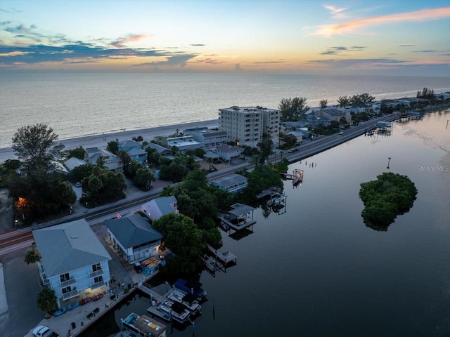 aerial view at dusk with a water view