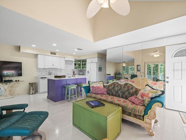 living room with light hardwood / wood-style flooring and ceiling fan