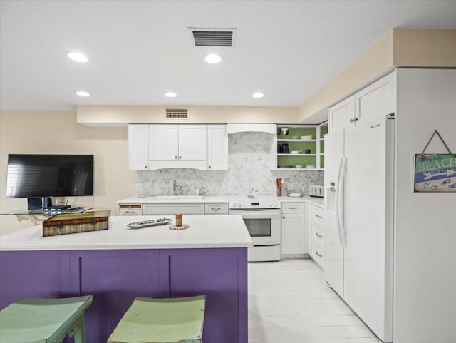 kitchen featuring white cabinetry, a breakfast bar, white appliances, kitchen peninsula, and decorative backsplash