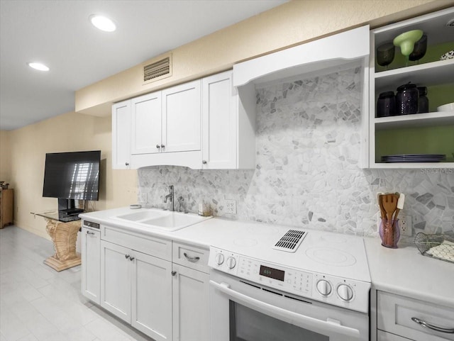 kitchen with white cabinetry, white range with electric cooktop, tasteful backsplash, and sink