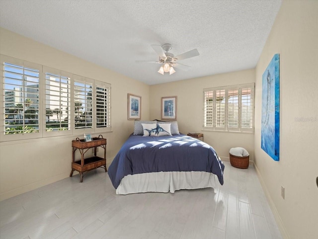 bedroom featuring a textured ceiling and ceiling fan