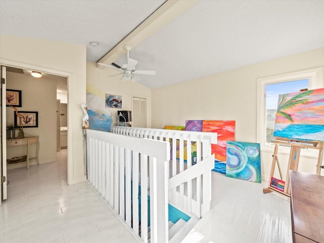 interior space featuring light tile patterned flooring, a textured ceiling, ceiling fan, vaulted ceiling, and a closet