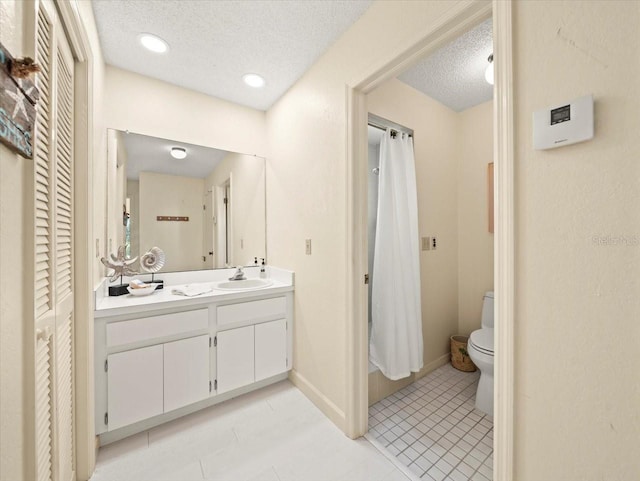 bathroom featuring vanity, tile patterned flooring, toilet, and a textured ceiling