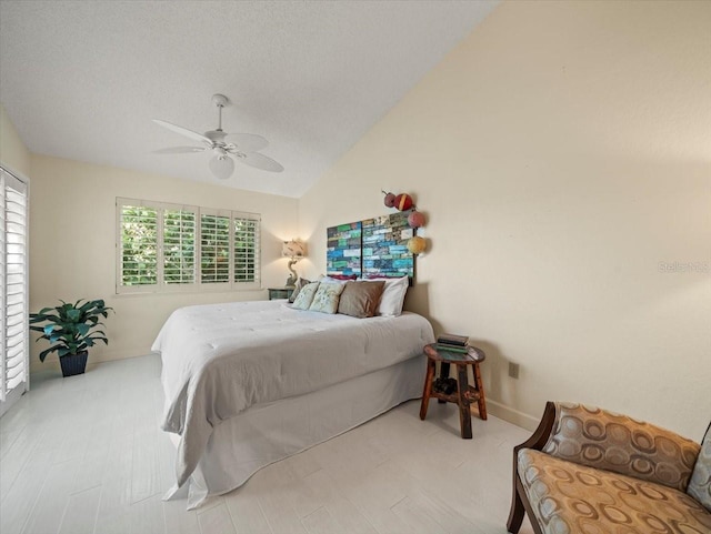 bedroom with light hardwood / wood-style flooring, high vaulted ceiling, and ceiling fan