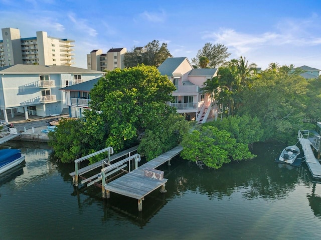 dock area with a balcony and a water view