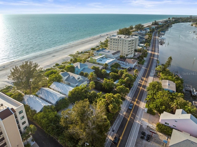 bird's eye view featuring a water view and a beach view