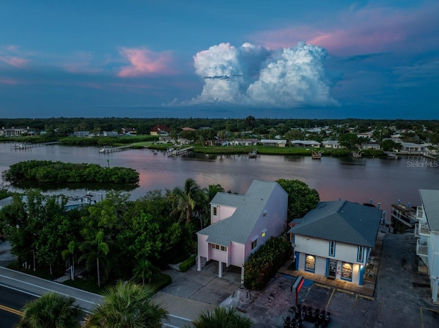 aerial view at dusk with a water view