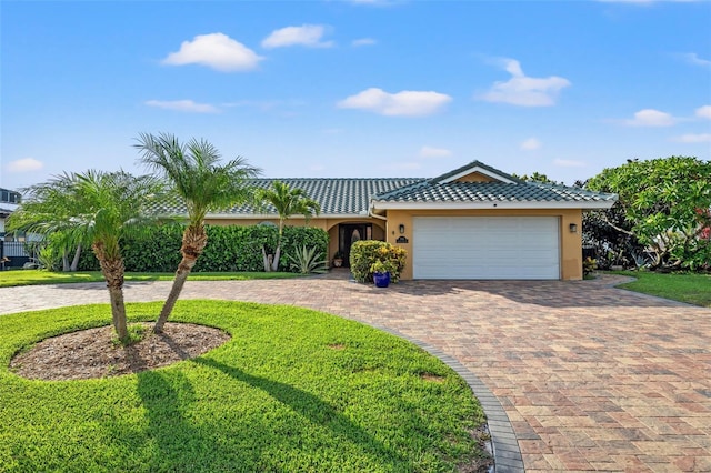 view of front facade with a garage and a front lawn