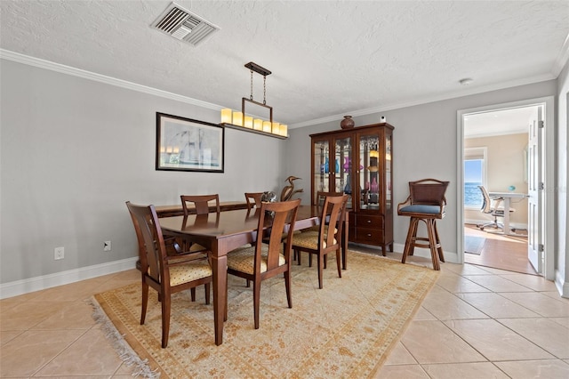 tiled dining room featuring ornamental molding, a water view, and a textured ceiling