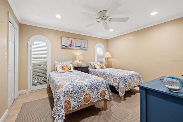 bedroom featuring ornamental molding, ceiling fan, and light tile patterned flooring