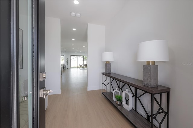 hallway with light hardwood / wood-style flooring