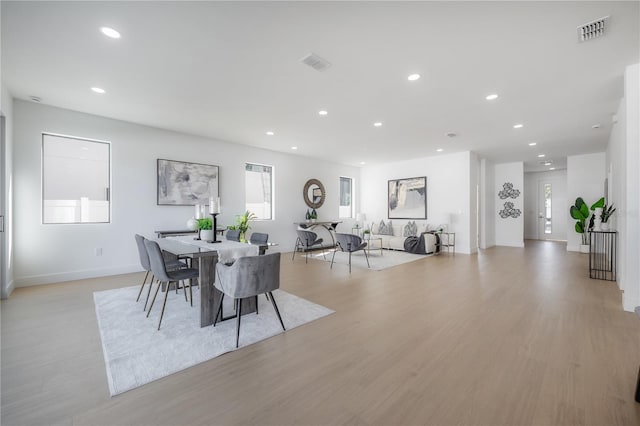 dining area with a healthy amount of sunlight and light hardwood / wood-style floors