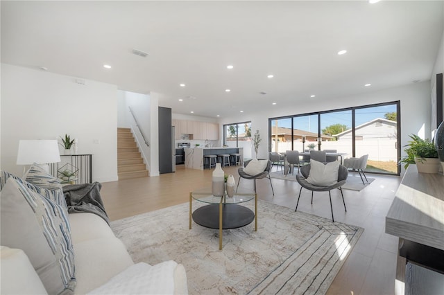 living room featuring sink and light hardwood / wood-style floors