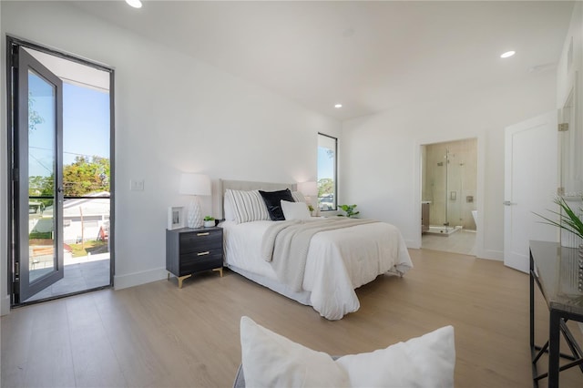 bedroom featuring light hardwood / wood-style flooring, access to outside, and ensuite bathroom