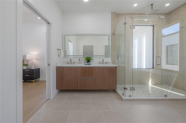 bathroom with vanity, a shower with shower door, and tile patterned flooring