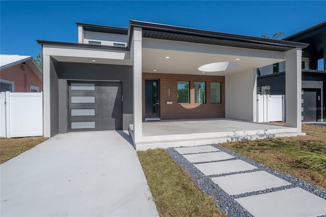 view of front of property with a porch and a garage