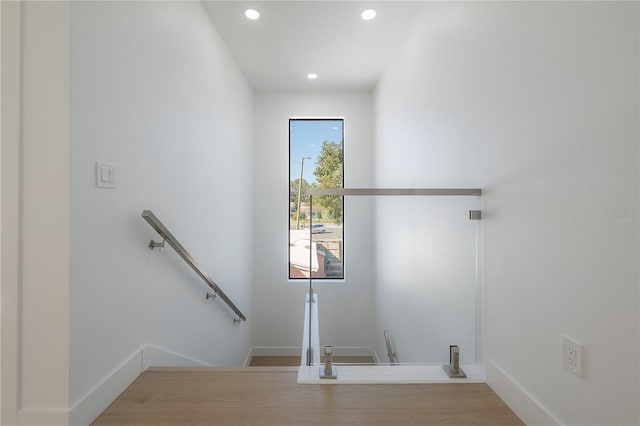 laundry room featuring wood finished floors, recessed lighting, and baseboards
