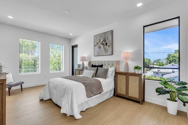 bedroom featuring recessed lighting, baseboards, and light wood-type flooring