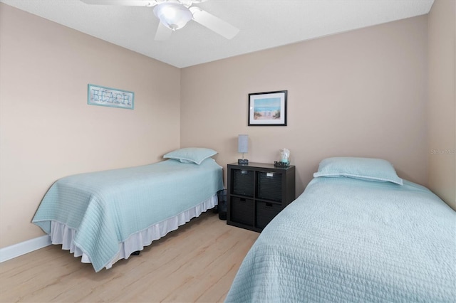 bedroom featuring light wood-type flooring and ceiling fan