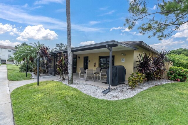 view of property exterior featuring a patio and a yard