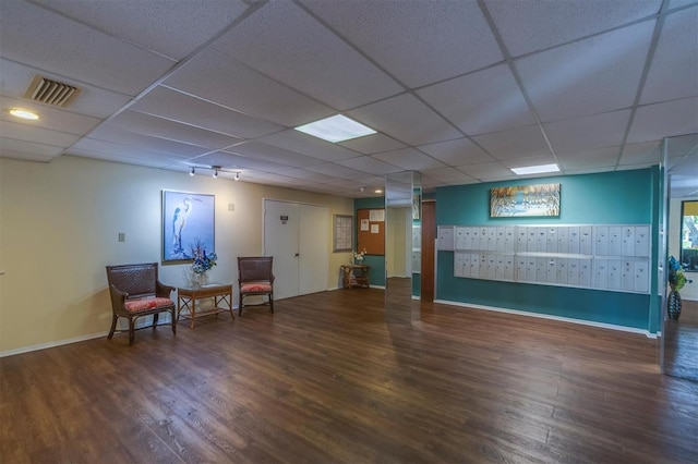 interior space with wood-type flooring and a drop ceiling