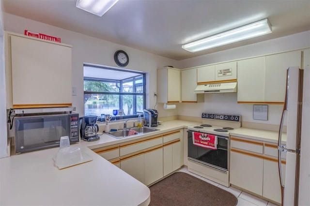 kitchen featuring light tile patterned flooring, sink, and white appliances