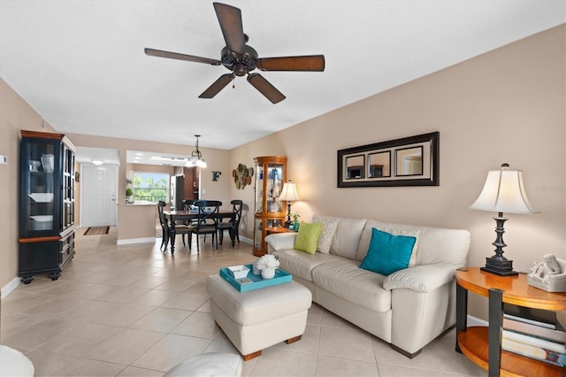 tiled living room with ceiling fan