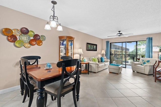 dining room featuring a textured ceiling, ceiling fan with notable chandelier, and light tile patterned flooring