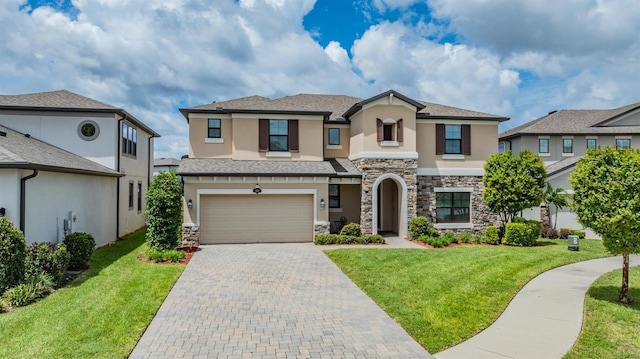 view of front of house featuring a front yard, decorative driveway, an attached garage, and stucco siding