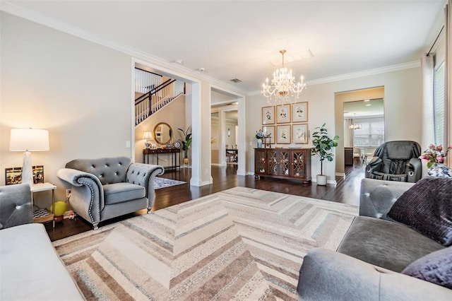 living room with crown molding, dark hardwood / wood-style flooring, and a notable chandelier