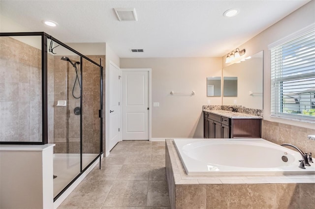 bathroom featuring vanity, plus walk in shower, and tile patterned flooring