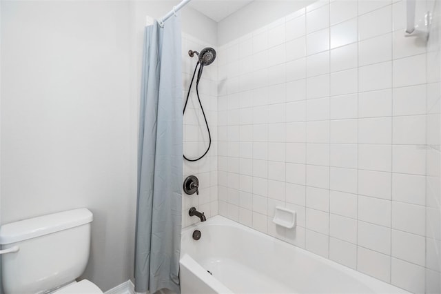 bathroom with shower / bath combination with curtain and toilet